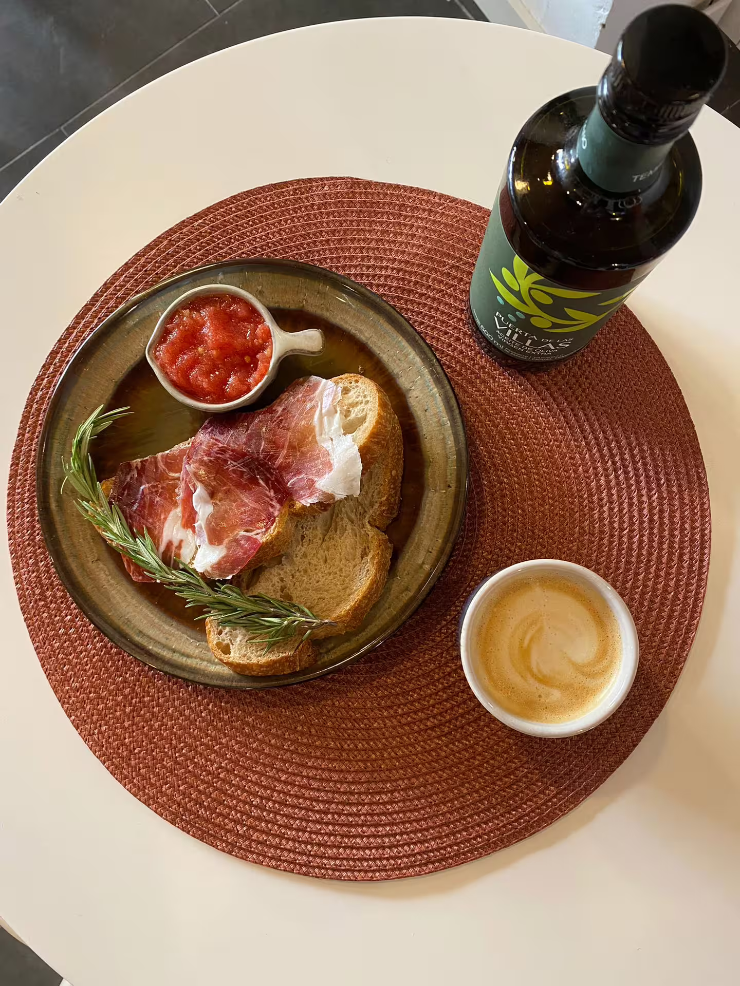 Traditional Spanish breakfast with jamón, bread, olive oil, and coffee, perfect for a Seville walking tour experience.