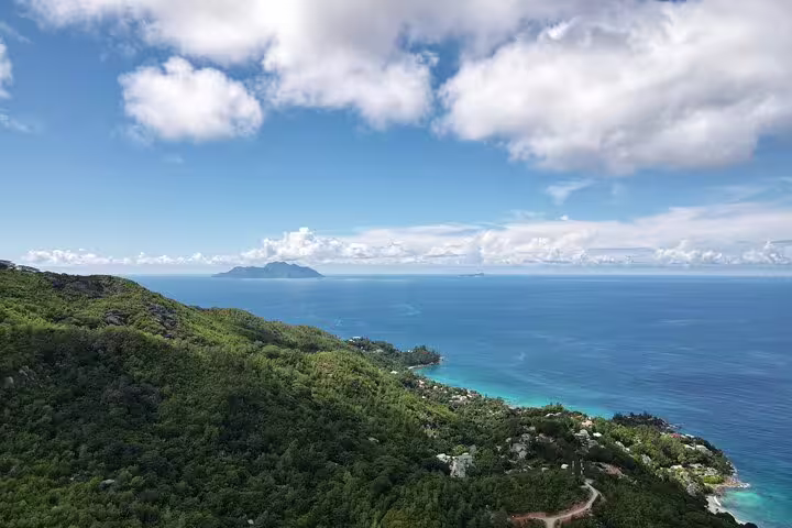 Scenic view of Seychelles' lush landscapes and turquoise waters, highlighting the beauty of a private island tour.