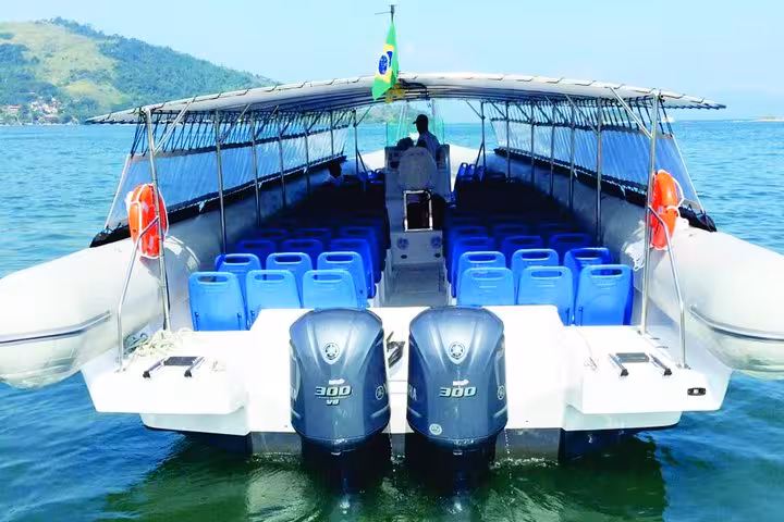 Spacious boat for shared shuttle transfer from Ilha Grande to Paraty, featuring comfortable seating and scenic views.