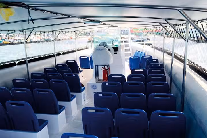 Interior of a comfortable shared shuttle boat with rows of seats, used for transfers from Ilha Grande to Paraty.