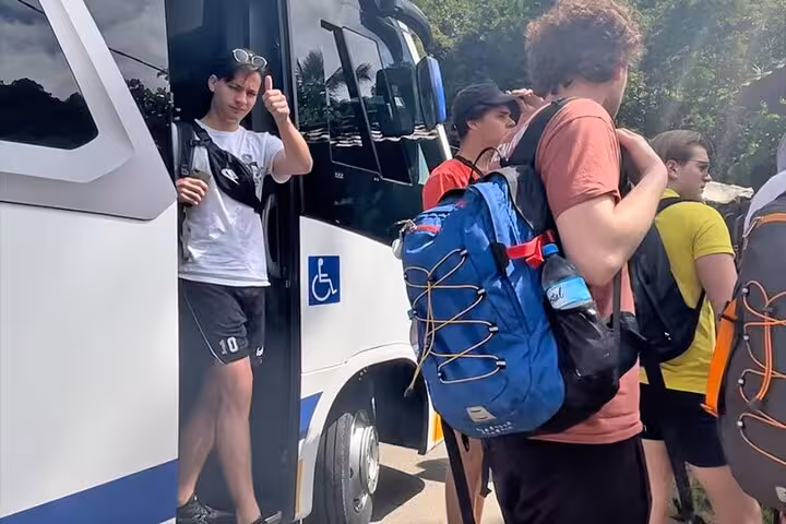 Tourists exiting a shuttle with backpacks, ready to explore Angra dos Reis after a shared ride from Rio de Janeiro.