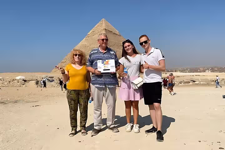 Travelers posing by the Great Pyramid of Giza on Sharm el Sheikh to Cairo air tour, pyramids excursion