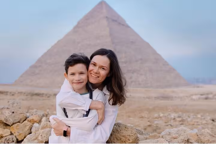 Family photo in front of the Great Pyramid on Sharm to Cairo by plane day trip with Pyramids and GEM tour