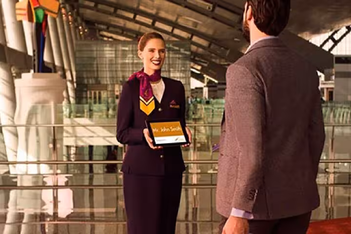 Driver greeting traveler at airport terminal for private Sharm El Sheikh Airport transfer with meet and assist service