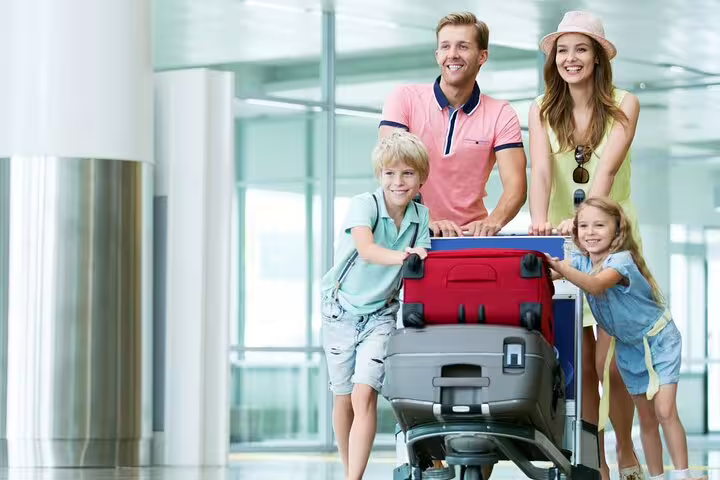 Family with luggage at terminal using Sharm El Sheikh Airport private transfer for stress-free arrival