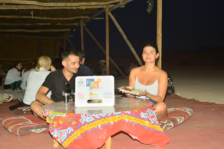 Guests enjoy Bedouin-style BBQ dinner in Sharm El-Sheikh desert camp after ATV and camel ride tour