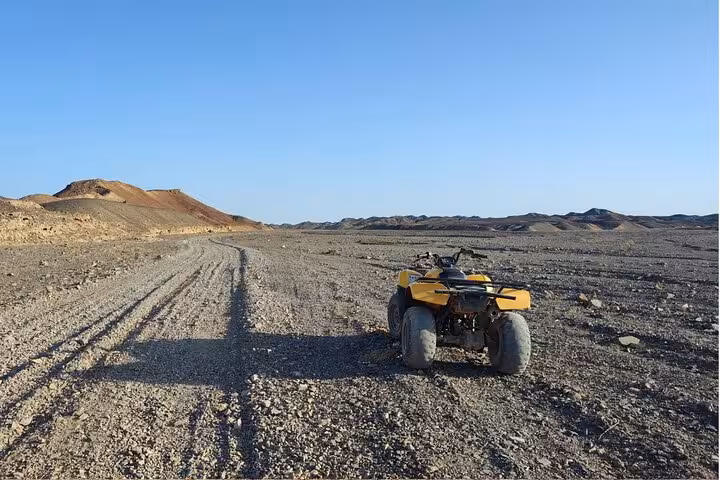 Single quad bike on a wide desert track in Sinai, Sharm El Sheikh, for an ATV adventure sunrise or sunset ride