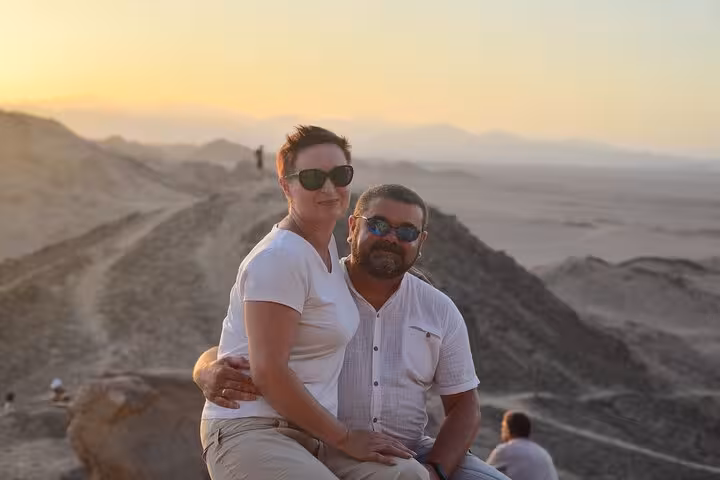 Couple enjoying sunset viewpoint in Sharm El-Sheikh desert during ATV quad safari and Bedouin BBQ dinner tour