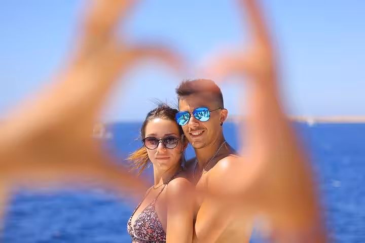 Couple on a day sail from Sharm El Sheikh to White Island and Ras Mohamed, posing with Red Sea views