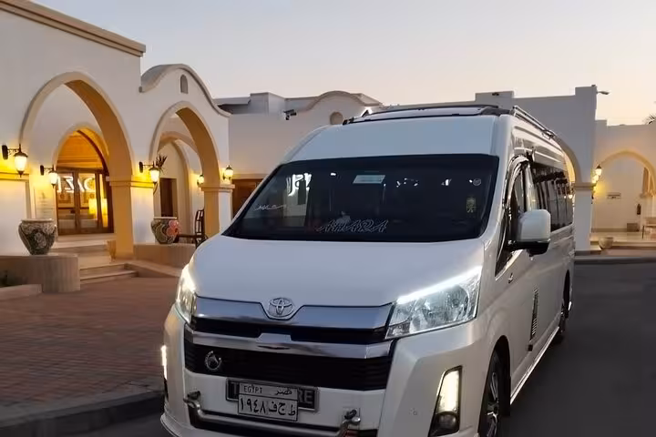 Private Sharm El Sheikh hotel transfer van parked at resort entrance, reliable door-to-door transport with AC