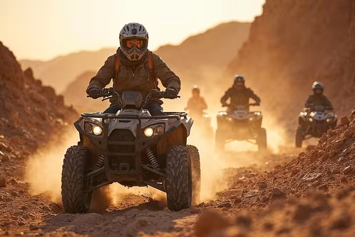 Quad biking through a rocky Sinai canyon near Dahab on a Sharm El-Sheikh Jeep Adventure to Blue Hole