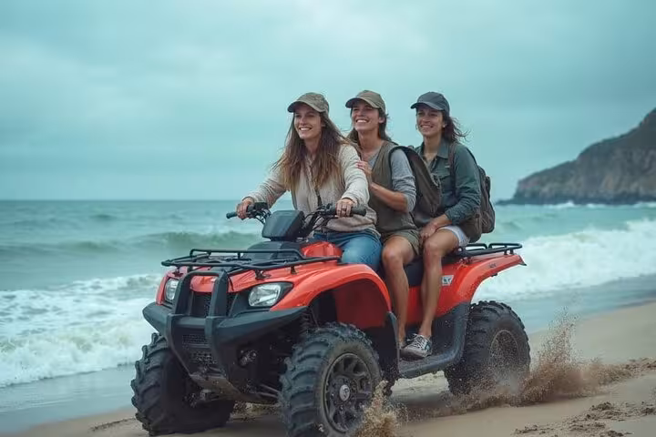 Friends riding ATV on Dahab beach during Sharm El-Sheikh jeep adventure to Blue Hole, canyon and coast