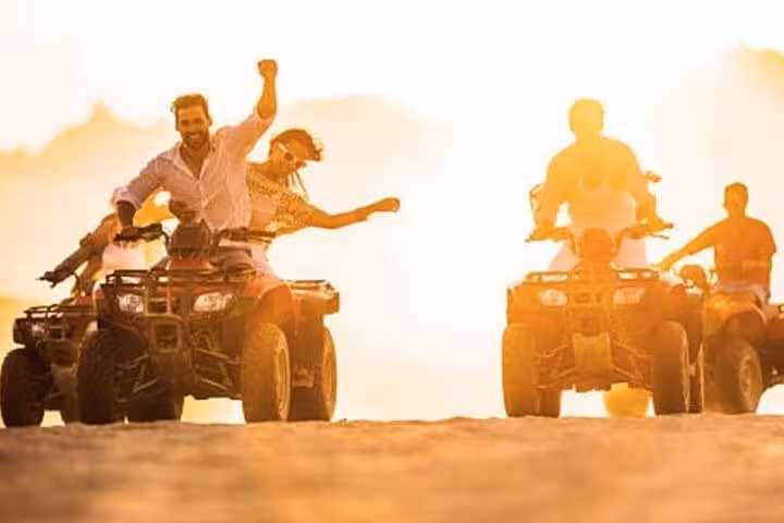 ATV riders crossing Sinai desert at sunset on Sharm El-Sheikh Jeep Adventure to Dahab and Blue Hole