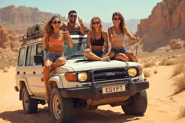 Friends on 4x4 jeep safari from Sharm El-Sheikh across Sinai Desert, heading to Dahab and the Blue Hole