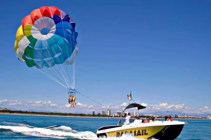 Sharm El Sheikh parasailing tour with speedboat and rainbow parachute, flying above the Red Sea coastline