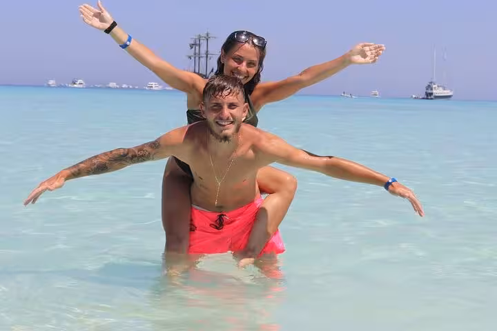 Couple enjoying shallow turquoise water at White Island on Ras Mohamed snorkeling trip from Sharm El-Sheikh