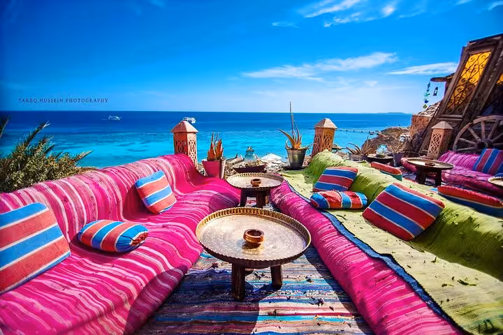 Seaside Sharm El-Sheikh cafe lounge with colorful cushions and low tables, perfect for shisha and drink included