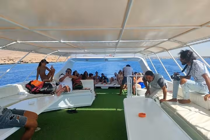 Spacious boat deck on Sharm El-Sheikh Ras Mohamed & White Island snorkeling tour, guests relaxing at sea