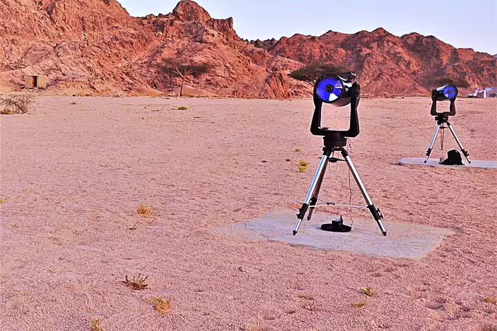 Telescopes set up in Sinai desert for Sharm El Sheikh stargazing tour with mountains at sunset