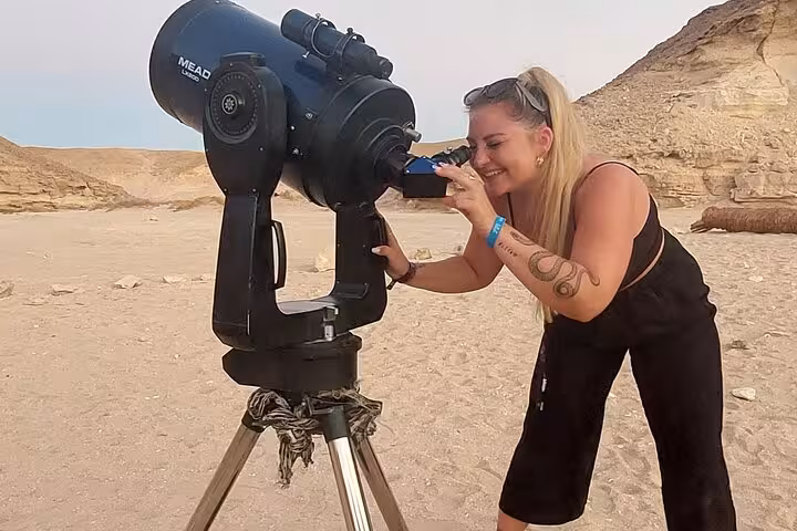 Tour guest stargazing with telescope in Sharm El-Sheikh desert, included in camel ride, BBQ dinner and show