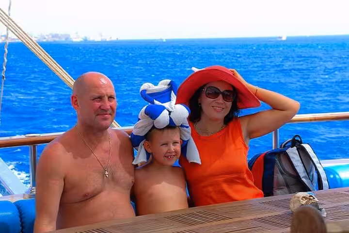 Family relaxing on deck during Sharm El Sheikh pirates sailing boat cruise to Ras Mohammed and White Island
