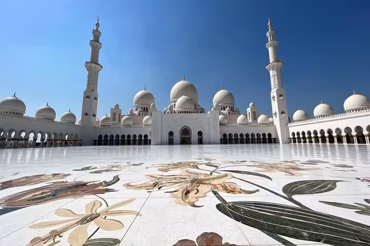 Sheikh Zayed Grand Mosque courtyard in Abu Dhabi on private guided tour with multilingual guide options