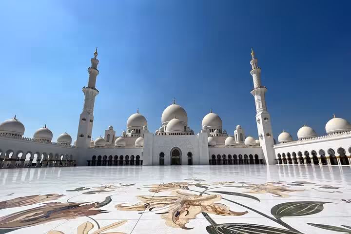 Sheikh Zayed Grand Mosque courtyard with domes, minarets and floral marble on a private Abu Dhabi city tour
