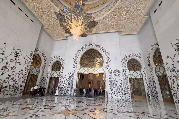 Stunning interior of Sheikh Zayed Grand Mosque featuring intricate floral marble inlay and grand chandelier