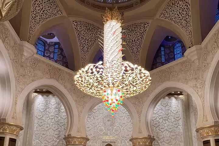 Stunning gold chandelier with colorful crystals inside Sheikh Zayed Grand Mosque Abu Dhabi tour
