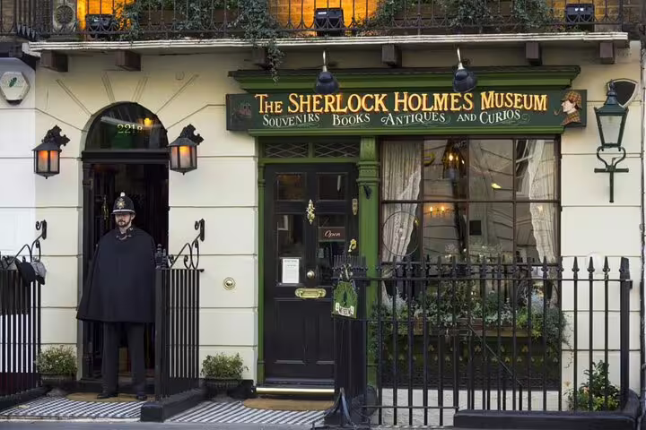 The Sherlock Holmes Museum facade at 221B Baker Street London with a police officer guard standing outside