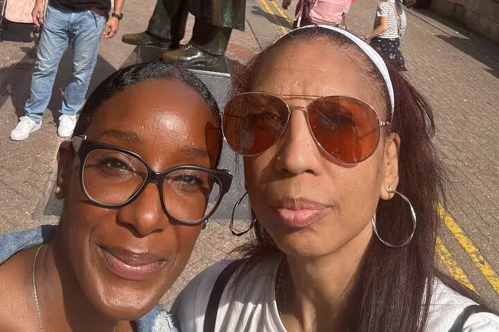 Two women taking a selfie on a London street during a Sherlock Holmes walking tour