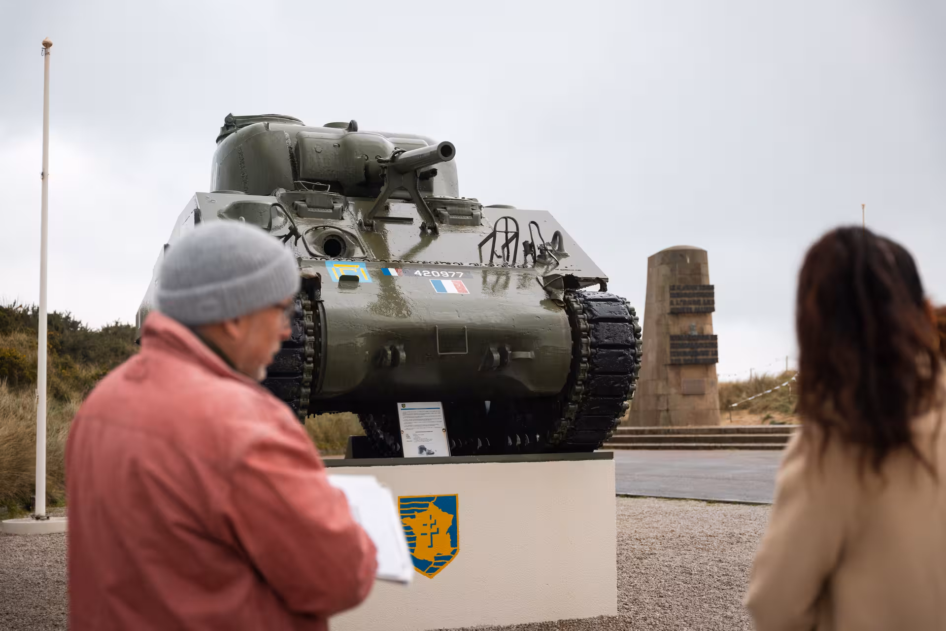 Visitors viewing a WWII Sherman tank memorial on a private guided Normandy D-Day tour from Honfleur or Deauville