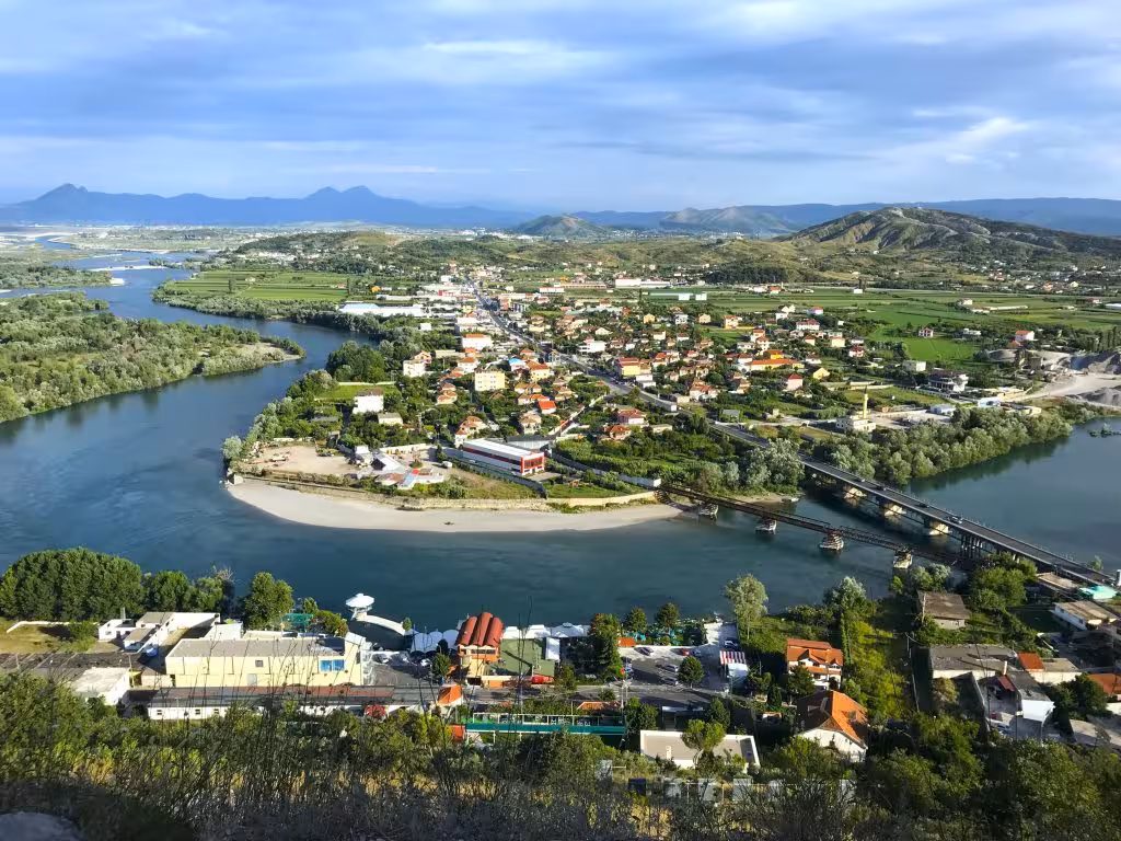 Scenic aerial view of Shkoder with rivers and mountains, featured in the Day Trip to Shkoder and Kruje tour.