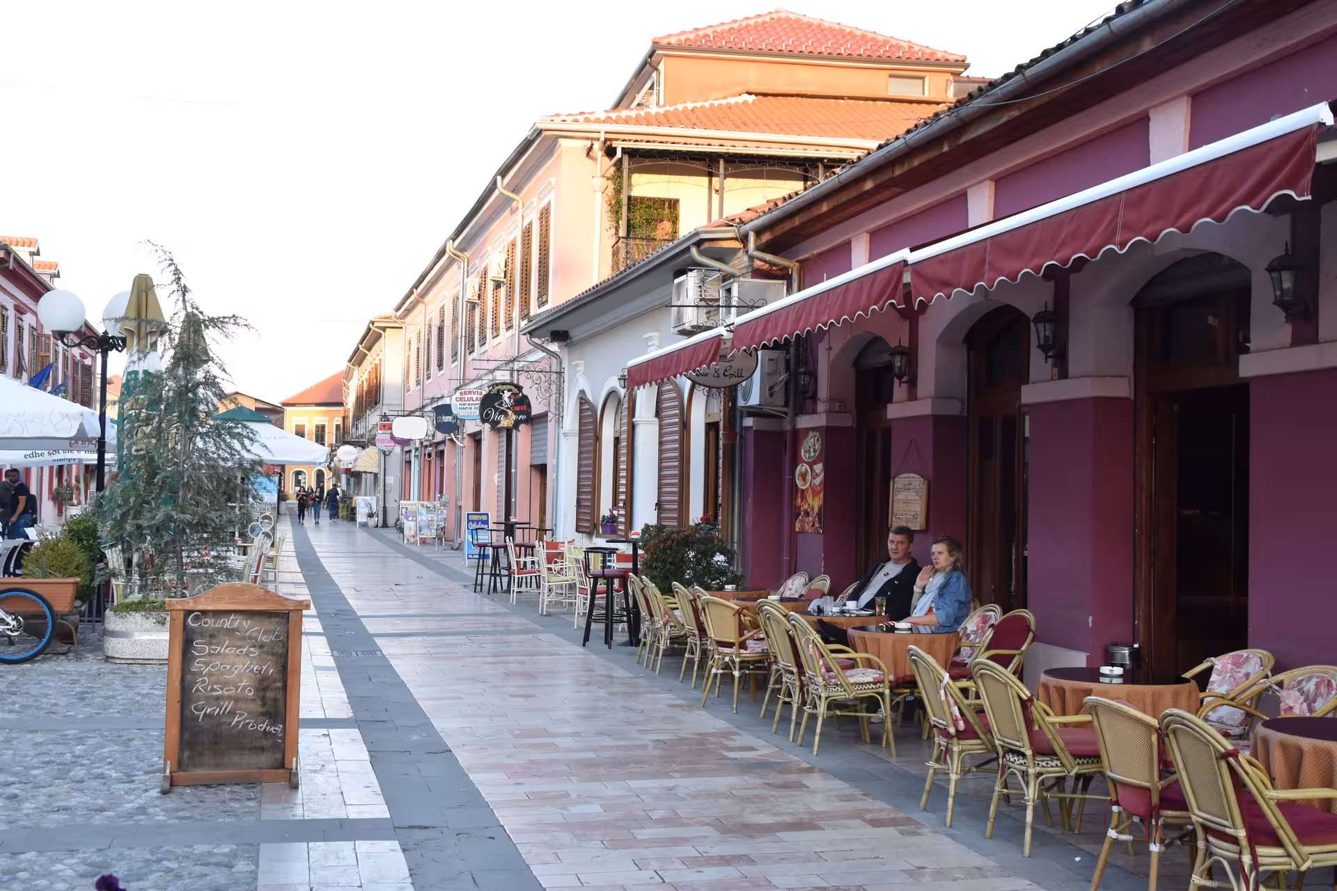 Relax at a charming cafe in Shkoder's bustling street, ideal for enjoying local cuisine on a day trip.
