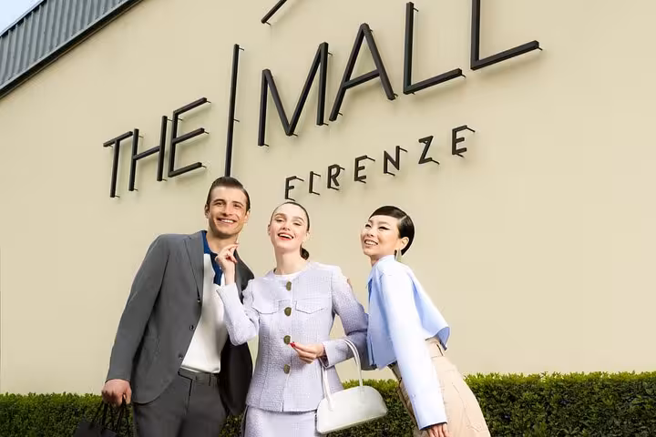 Happy shoppers at The Mall Firenze, a luxury shopping destination offering exclusive deals near Rome.
