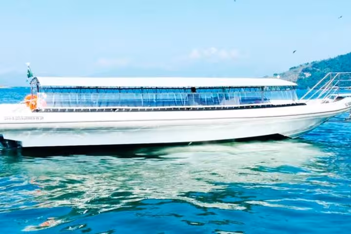 Sleek shuttle boat on clear waters, used for convenient transfers from Ilha Grande to Paraty.