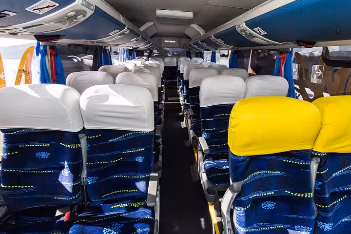 Spacious interior of a modern shuttle bus for comfortable travel from Ilha Grande to Paraty.