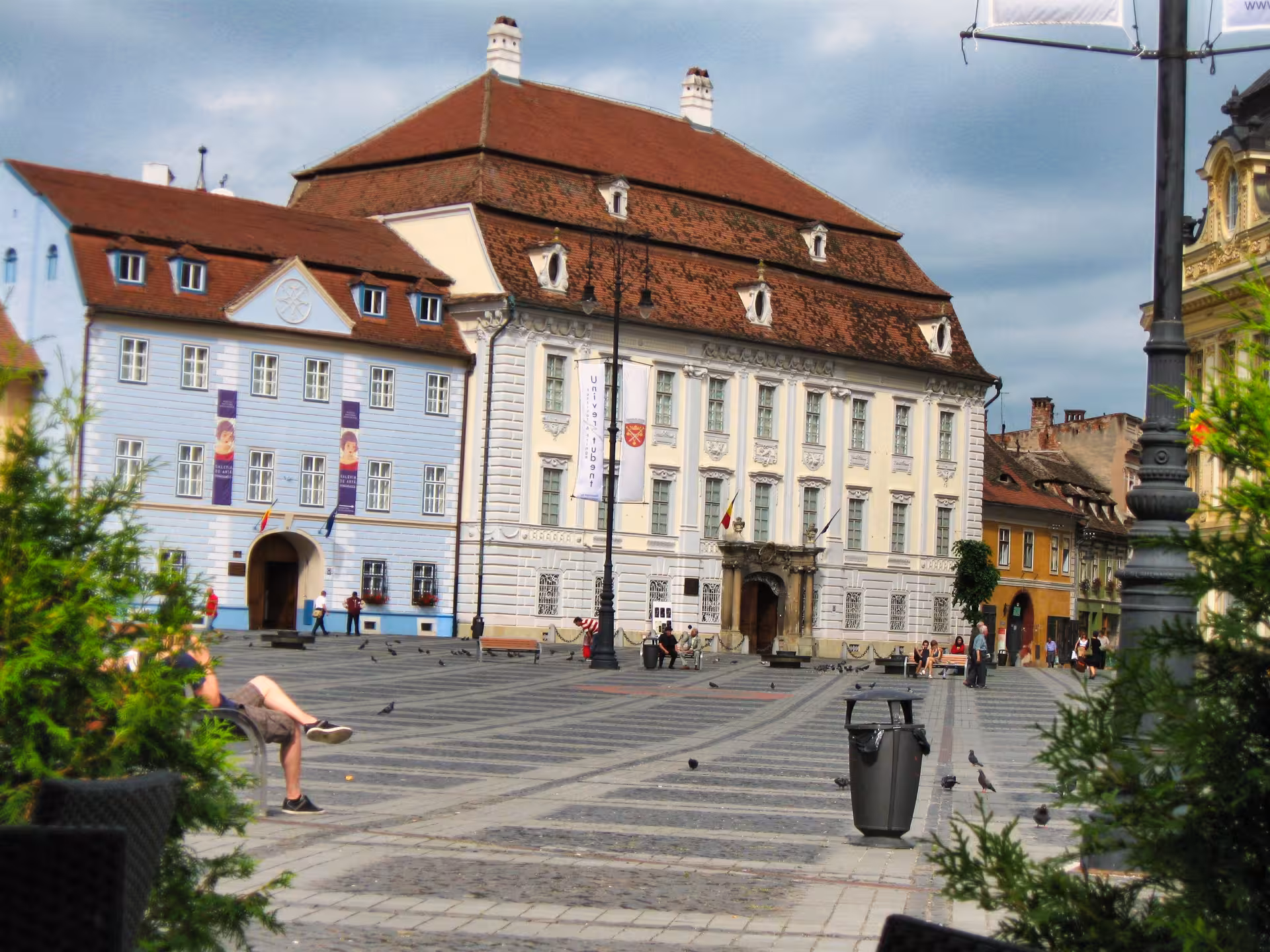 Historic Sibiu Grand Square showcasing baroque architecture and Brukenthal museum on a guided day trip from Cluj-Napoca