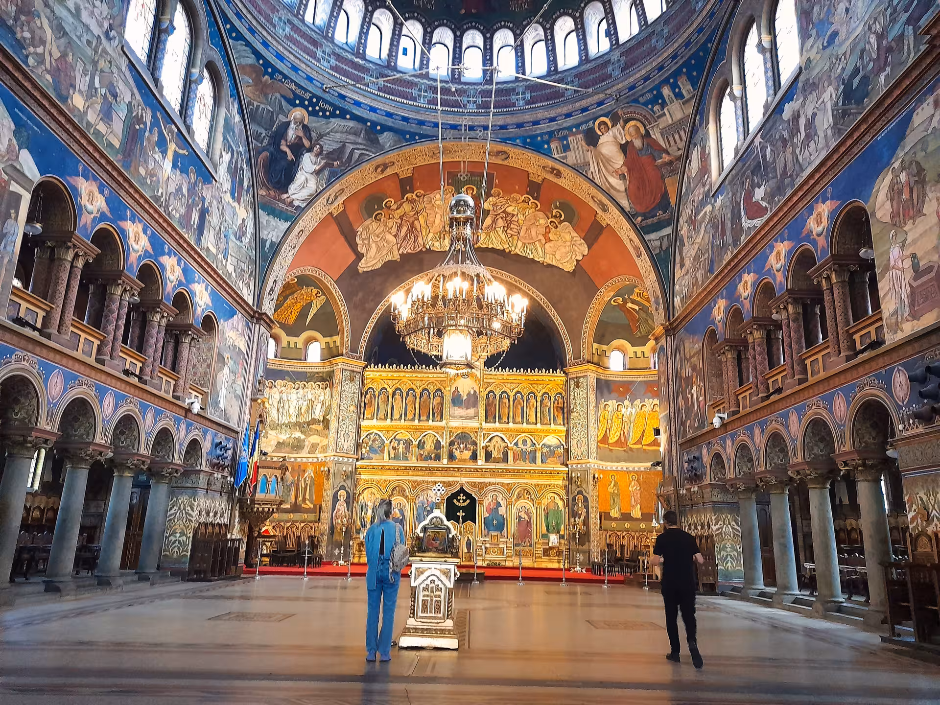 Stunning interior of Sibiu Orthodox Cathedral with golden iconostasis vibrant frescoes and grand chandelier visited on a day tour
