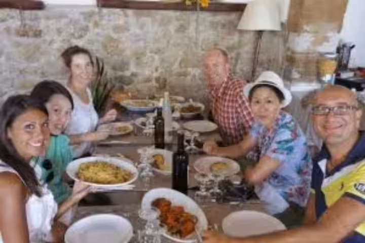 Group tasting Sicilian dishes and local wine on Marsala and Erice tour from Palermo with olive oil and salt