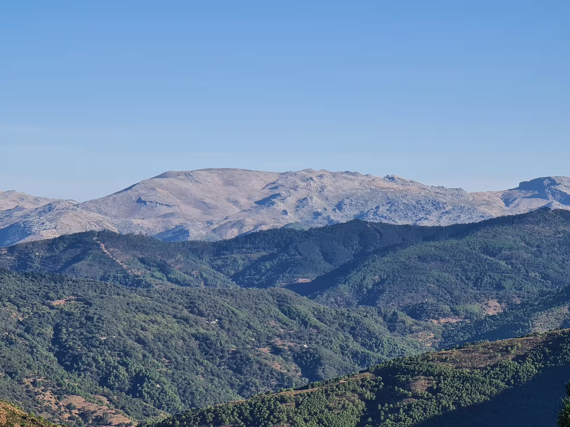 Expansive view of Sierra Bermeja mountains under clear blue skies, perfect for a private hiking adventure.