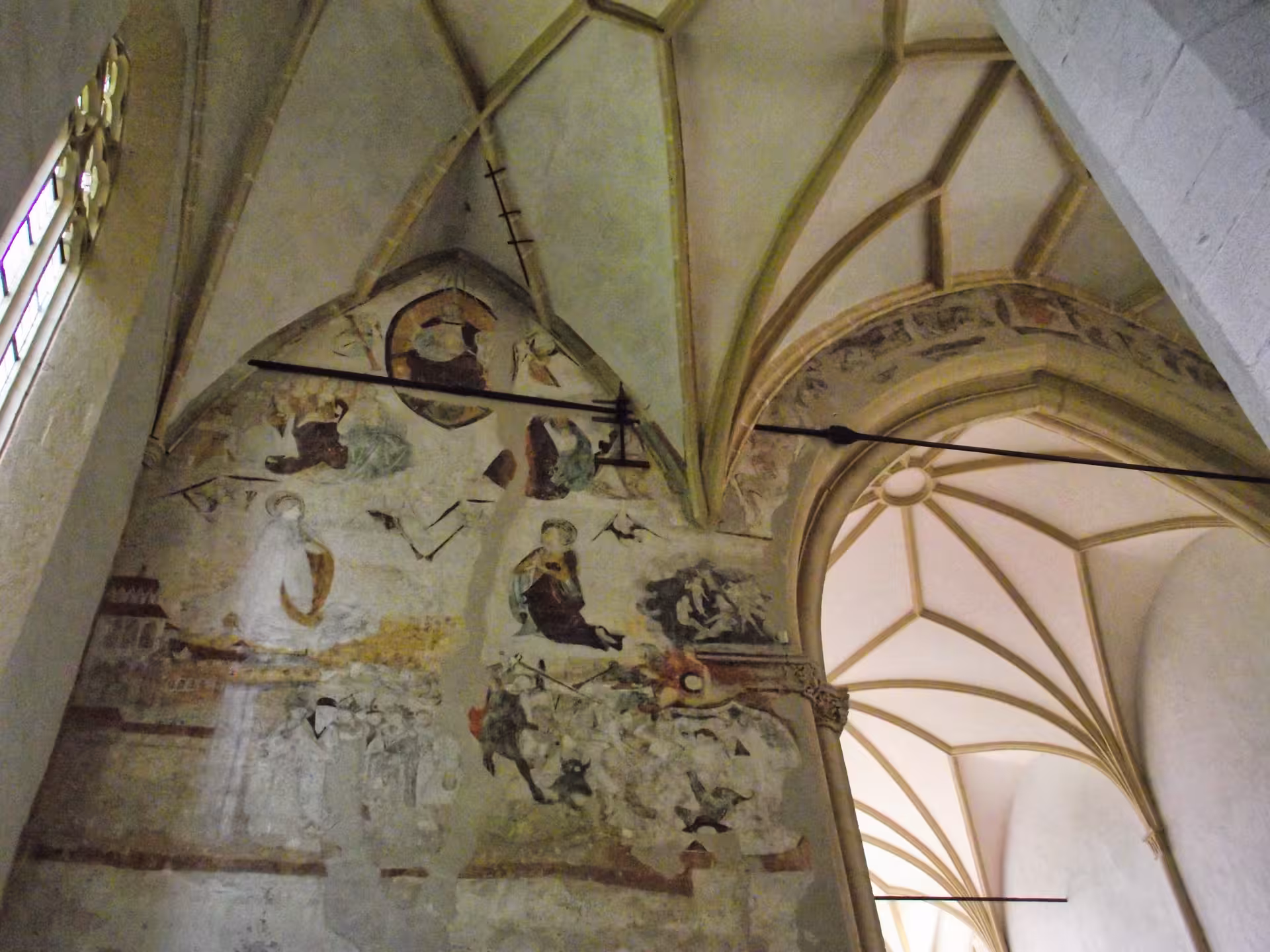 Medieval frescoes and Gothic vaulted ceiling inside a Sighisoara church