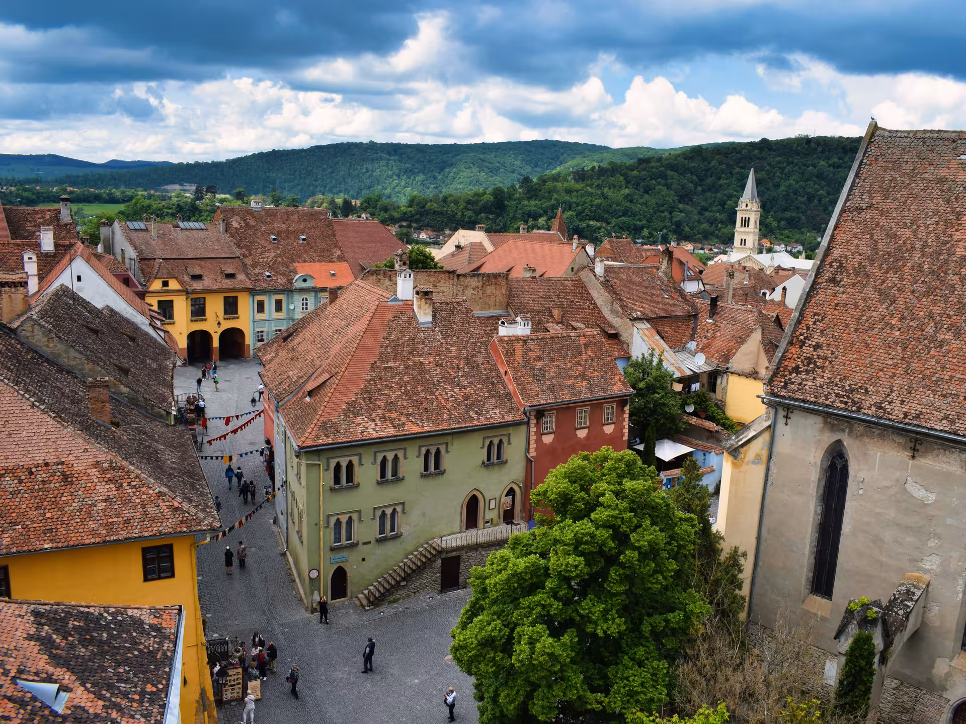 Aerial view of Sighisoara medieval citadel with colorful Saxon buildings and red-tiled roofs in Transylvania