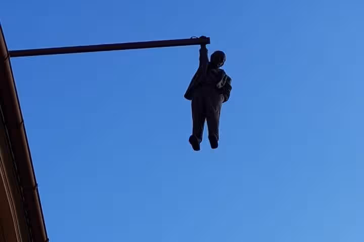Hanging statue of Sigmund Freud on Husova Street in Prague, seen on a small-group day trip from Vienna