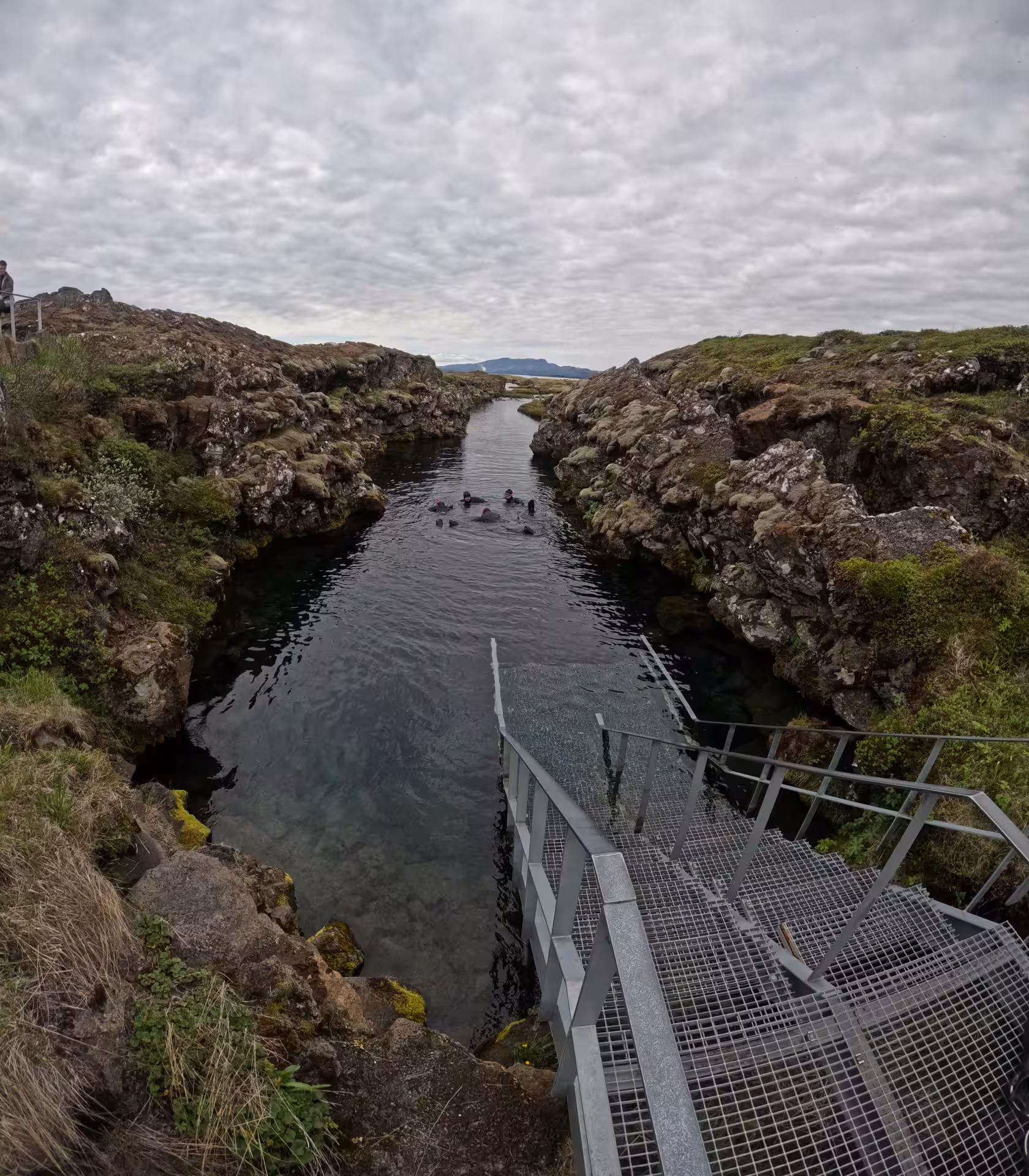 Snorkelers in Silfra fissure canyon between tectonic plates at Thingvellir National Park, Iceland