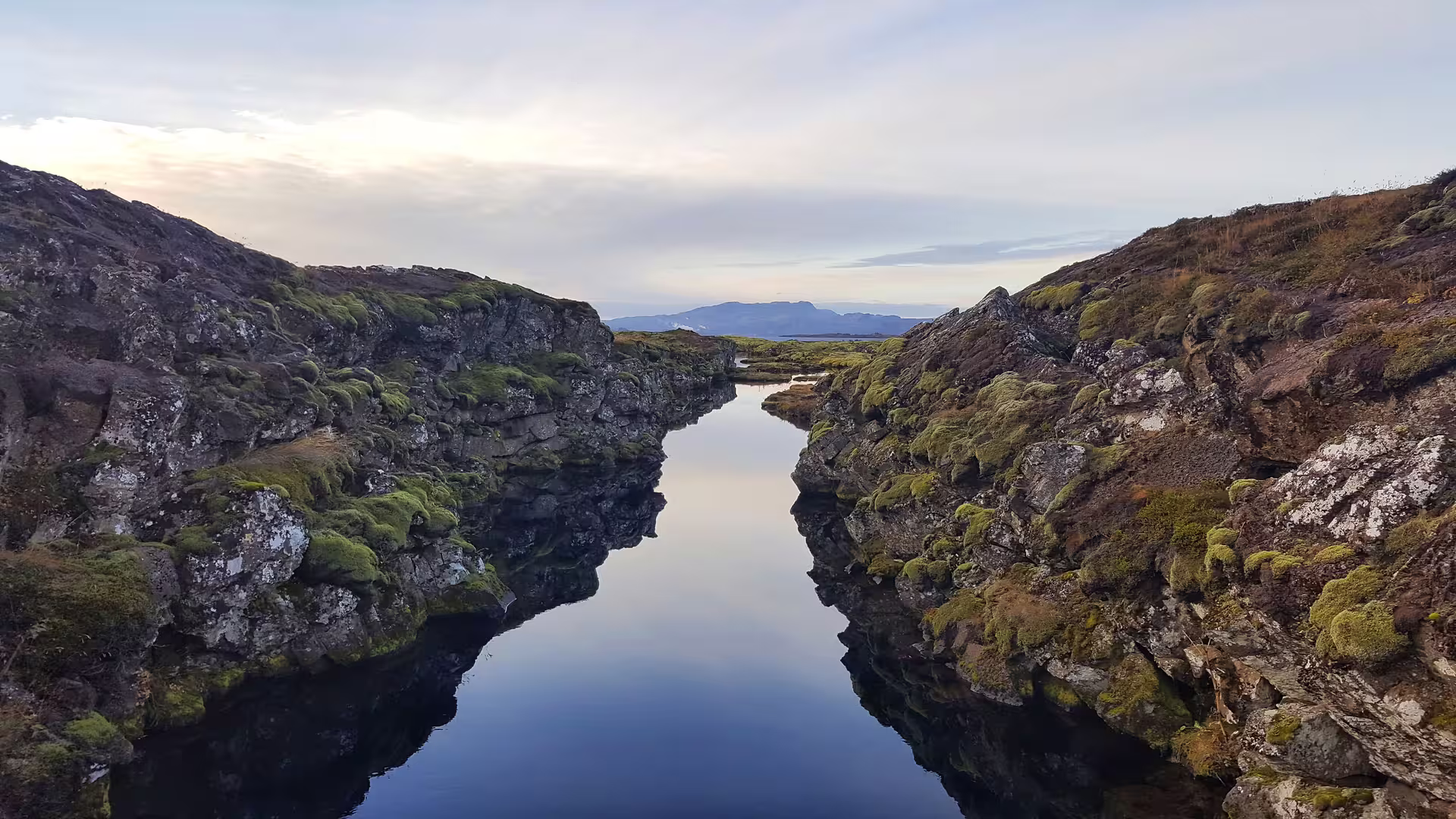 Explore the stunning Silfra fissure with crystal-clear waters and breathtaking views, perfect for snorkeling tours from Reykjavik.