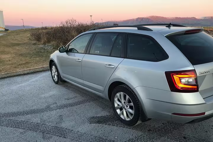 Silver Skoda Octavia estate car parked at sunset, used for Keflavik Airport private transfers to Reykjavik