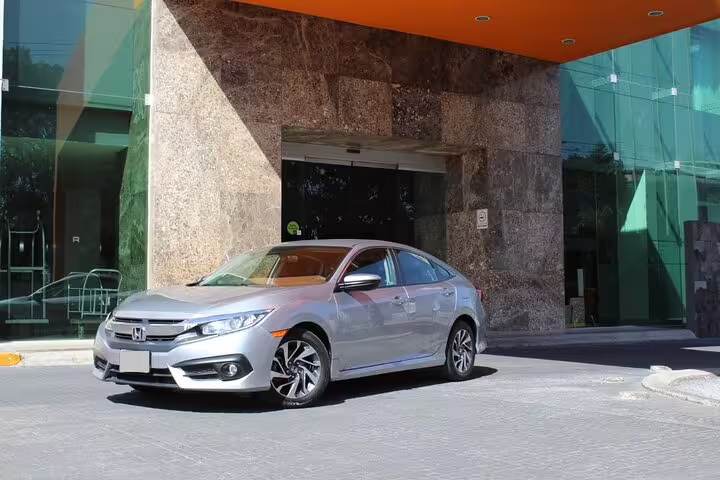 Silver Honda Civic sedan parked at Nassau hotel entrance for reliable cruise port private transfer service