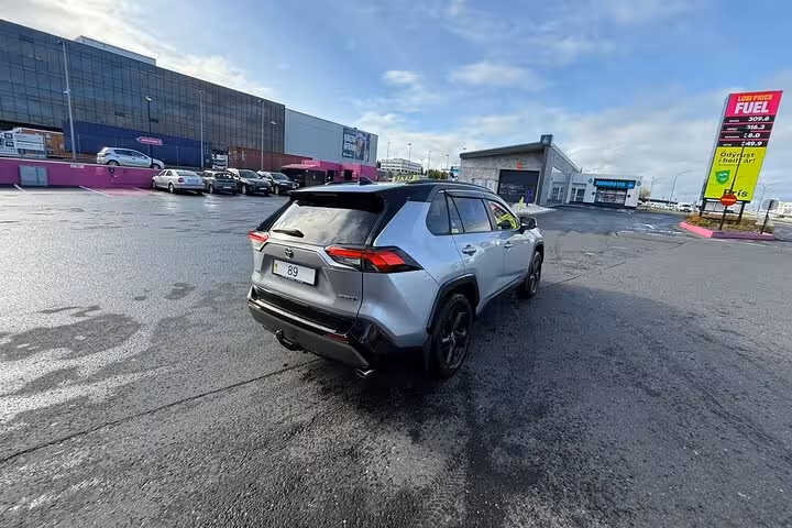 Silver Toyota RAV4 SUV parked in Reykjavik parking lot for private comfort transfer service