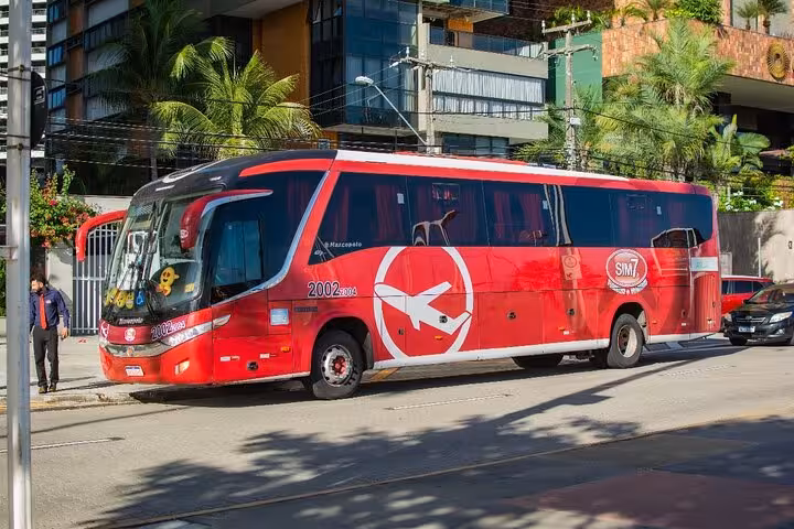 Red Sim7 coach in Fortaleza for Jericoacoara to Fortaleza transfer, safe air-conditioned bus ride